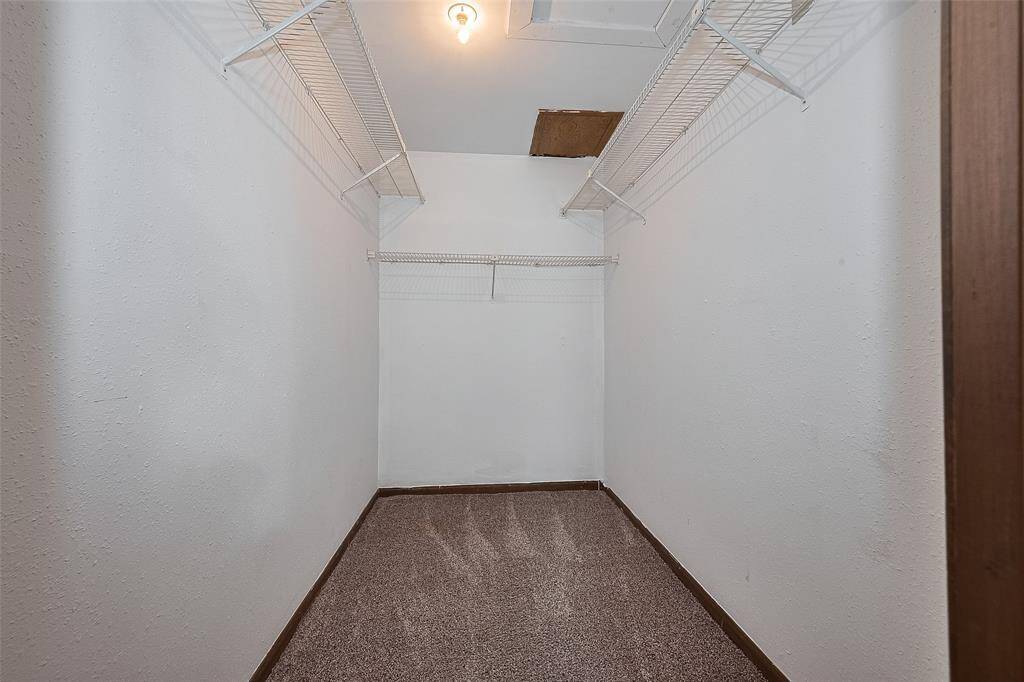 A generously sized walk-in closet offers plenty of storage and organization potential.