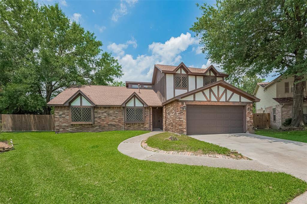 The extended driveway and spacious two-car garage offer plenty of parking and storage space.
