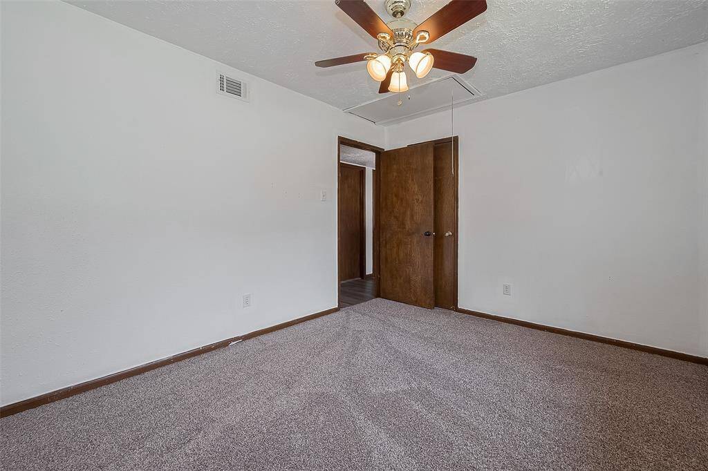 Looking across the room, you’ll find easy access to the hall and a ceiling fan to keep things comfortable.