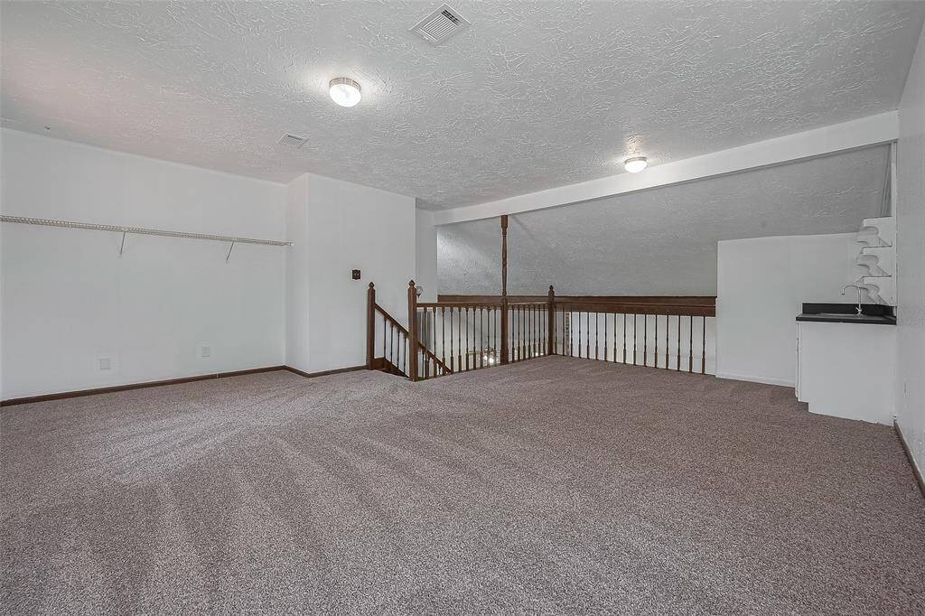 This expansive upstairs game room offers plenty of flexible space for lounging, working, or play