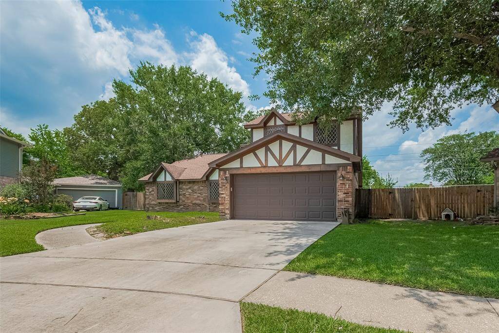 A lush, tree-shaded front yard provides a peaceful setting on a quiet street.