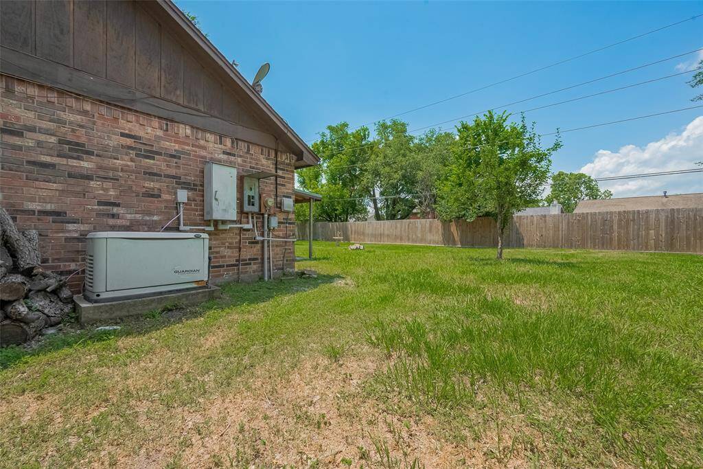 A spacious side yard wraps around the home, offering room for storage, gardening, or additional outdoor living.