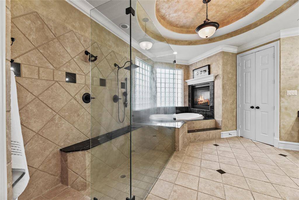 The exquisite two-sided fireplace adjacent to the bath creates an unparalleled ambiance, seamlessly warming both the bathroom and the adjoining bedroom, elevating relaxation to the ultimate level of indulgence.