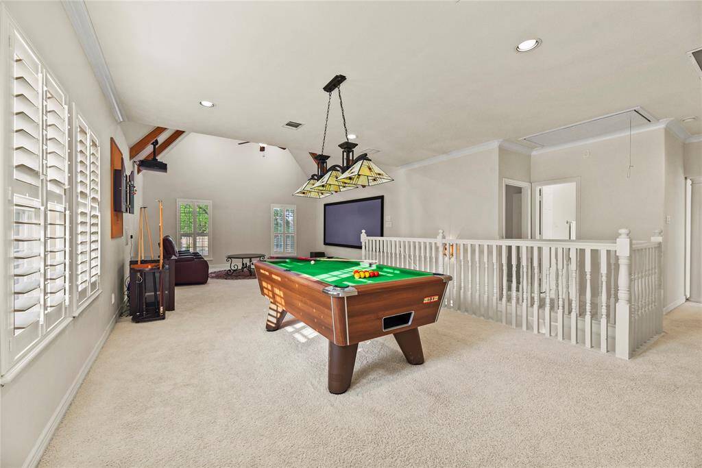 Adjacent to the media room, the expansive game room, offering a versatile and stylish space perfect for recreation and relaxation.