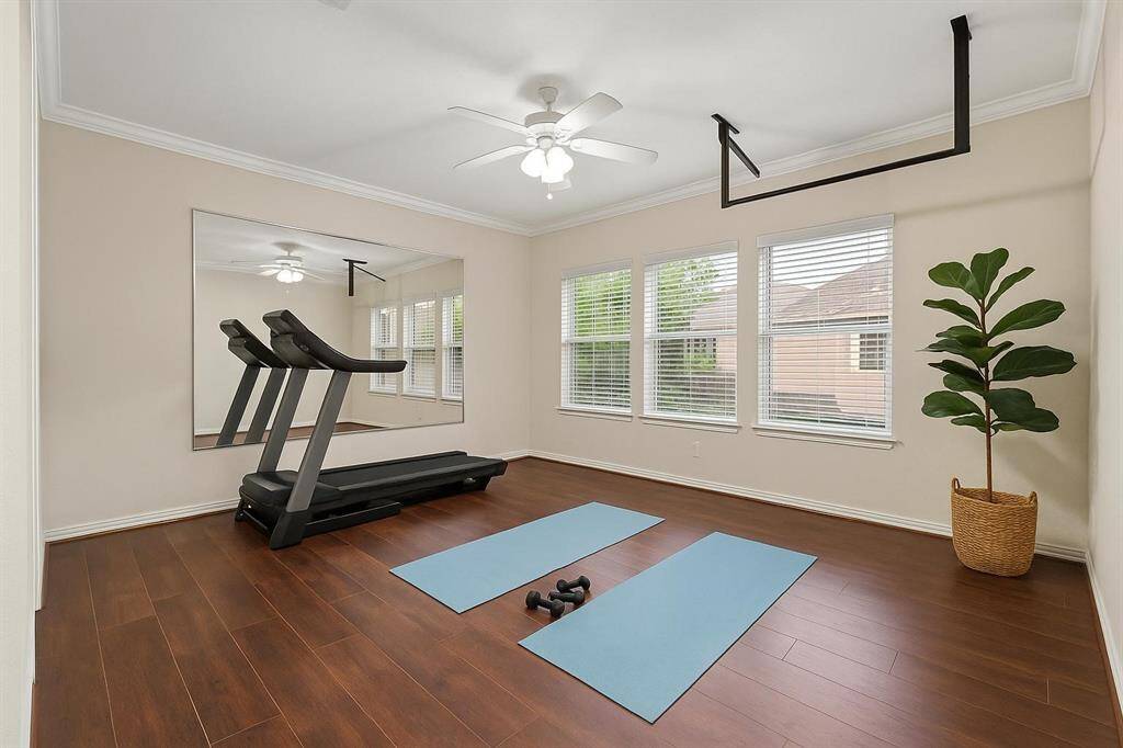 Also upstairs is this versatile flex room is currently transformed into a sophisticated exercise space, thoughtfully designed to inspire wellness and invigorate the body within a stylish, functional setting.