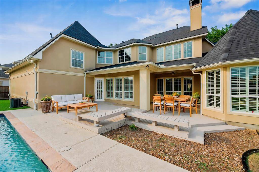 Step outside to the backyard oasis, where a spacious covered patio invites relaxation and entertaining in any weather. A custom-crafted deck extends the living space, seamlessly blending elegance with outdoor comfort and creating a perfect sanctuary for gatherings or quiet moments alike.