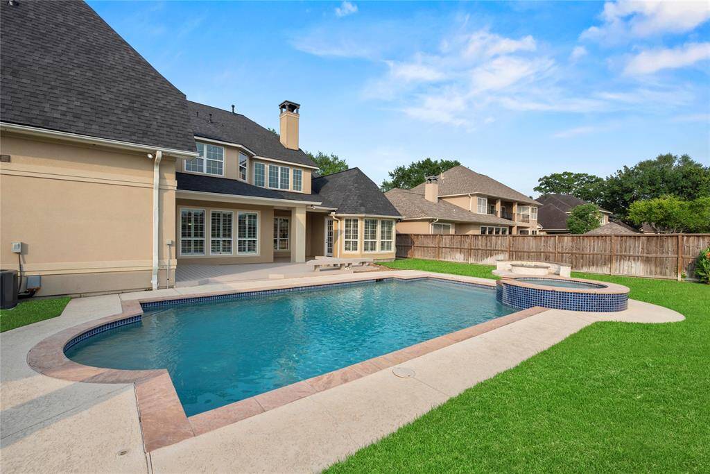 A lush, green yard surrounds the gorgeous pool—truly, what more could you ask for?