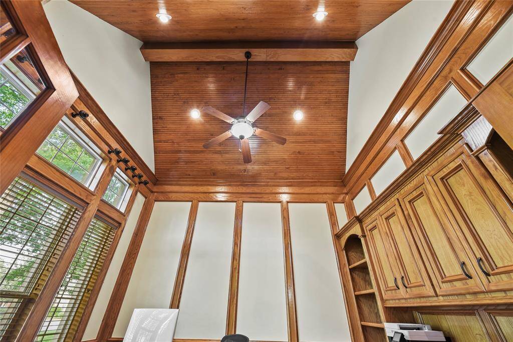 The soaring ceiling, beautifully accented with custom wood detailing, is yet another upscale feature that elevates the home's architectural distinction.