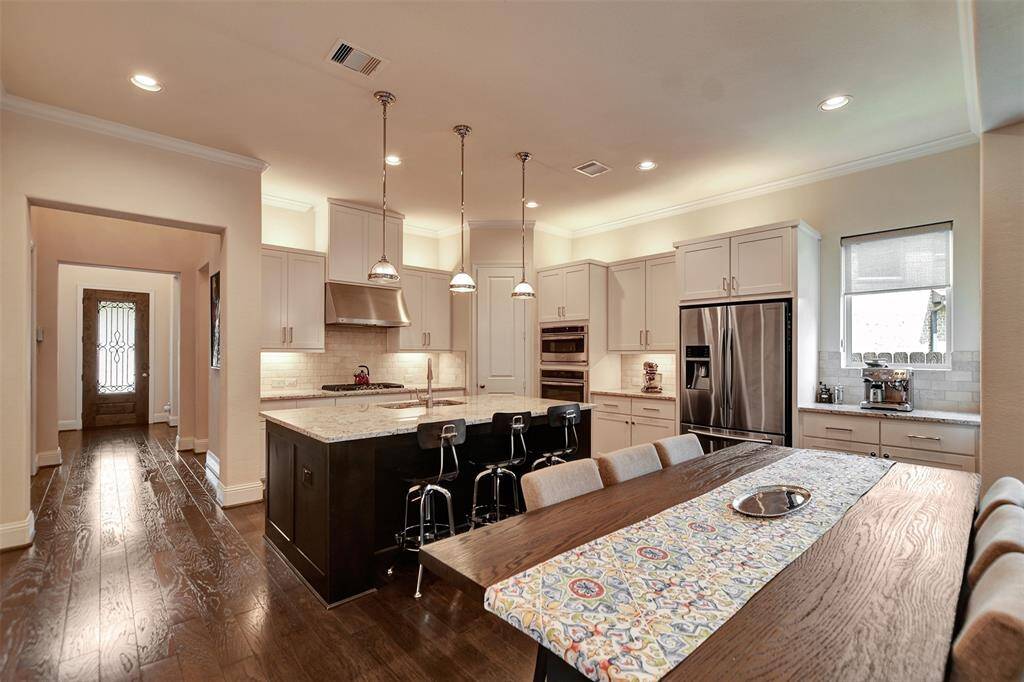 Natural light pours in, highlighting the seamless flow from the entryway to the heart of the home.