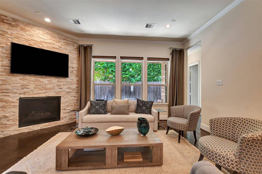 This photo showcases a cozy living room with an upgraded modern gas fireplace for those chilly nights