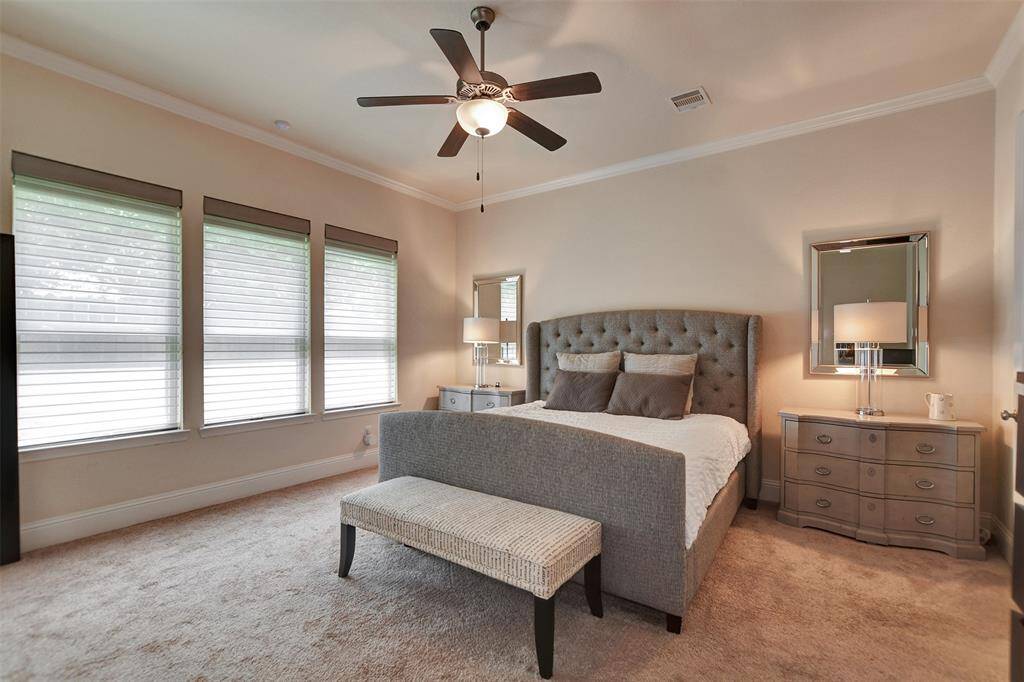 The primary room is spacious, modern, with neutral colors and lots of natural light.