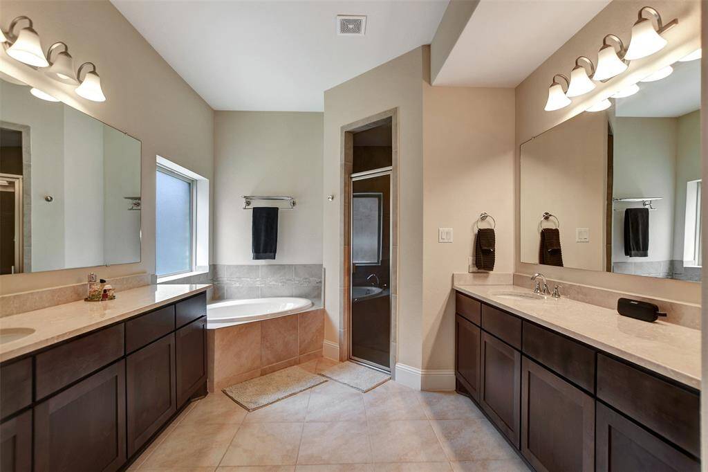 His and hers vanities and large counter tops with lots cabinets space.