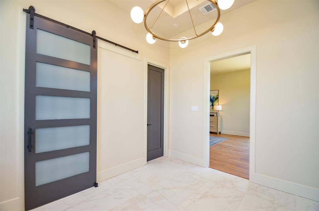 Door to primary closet and water closet. Open door leads to primary bedroom.