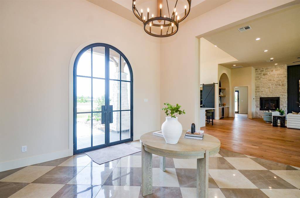 Front door, foyer. Kitchen in background.