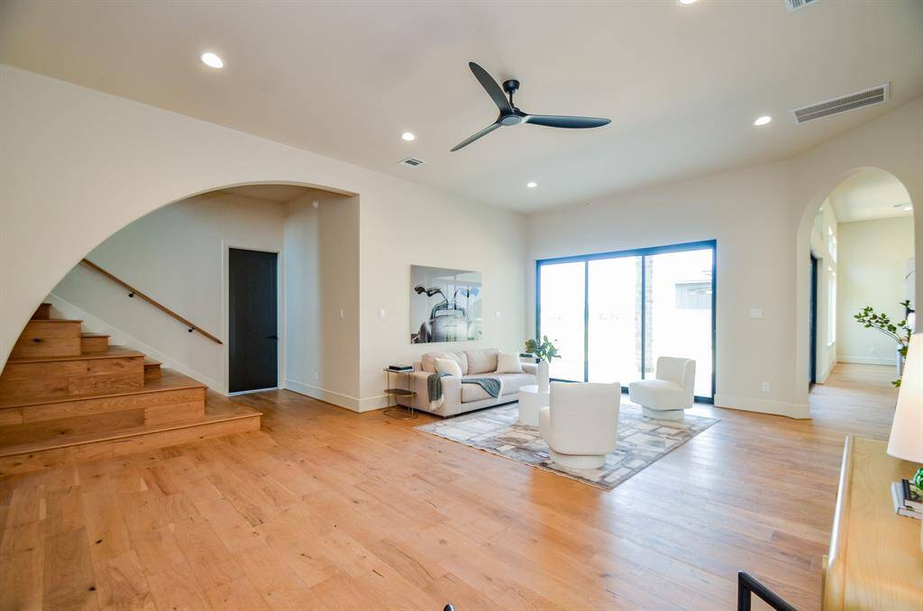 Another view of the stairs and a living area leads to patio.