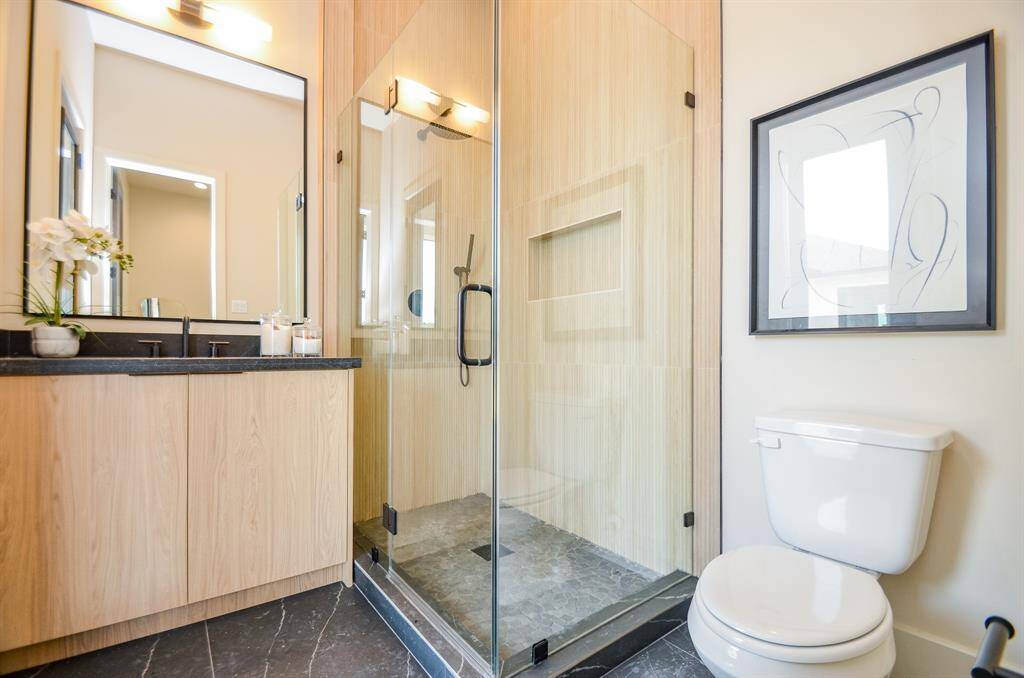 One of 3 full bathrooms downstairs.