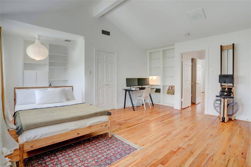 An alternate view of the primary bedroom, looking toward the seating area and entry.