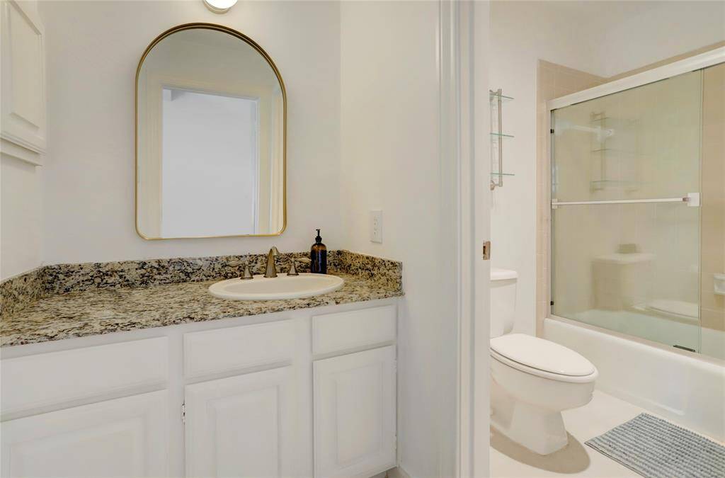 An alternate view of the primary bathroom looking toward the shower/tub.