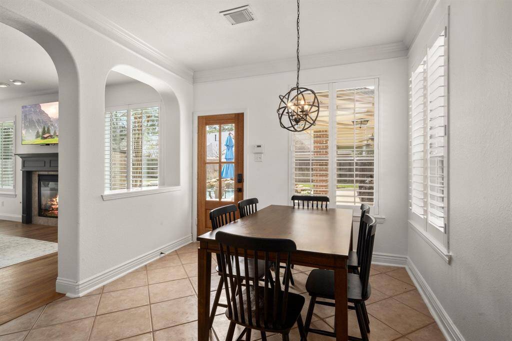 Breakfast area is light and bright! Newly installed custom door leads to the pool area.