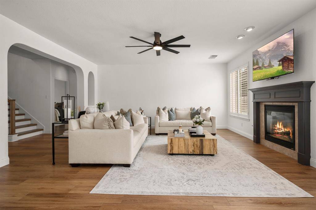 Family room is spacious with updated lighting and new windows overlooking the pool.