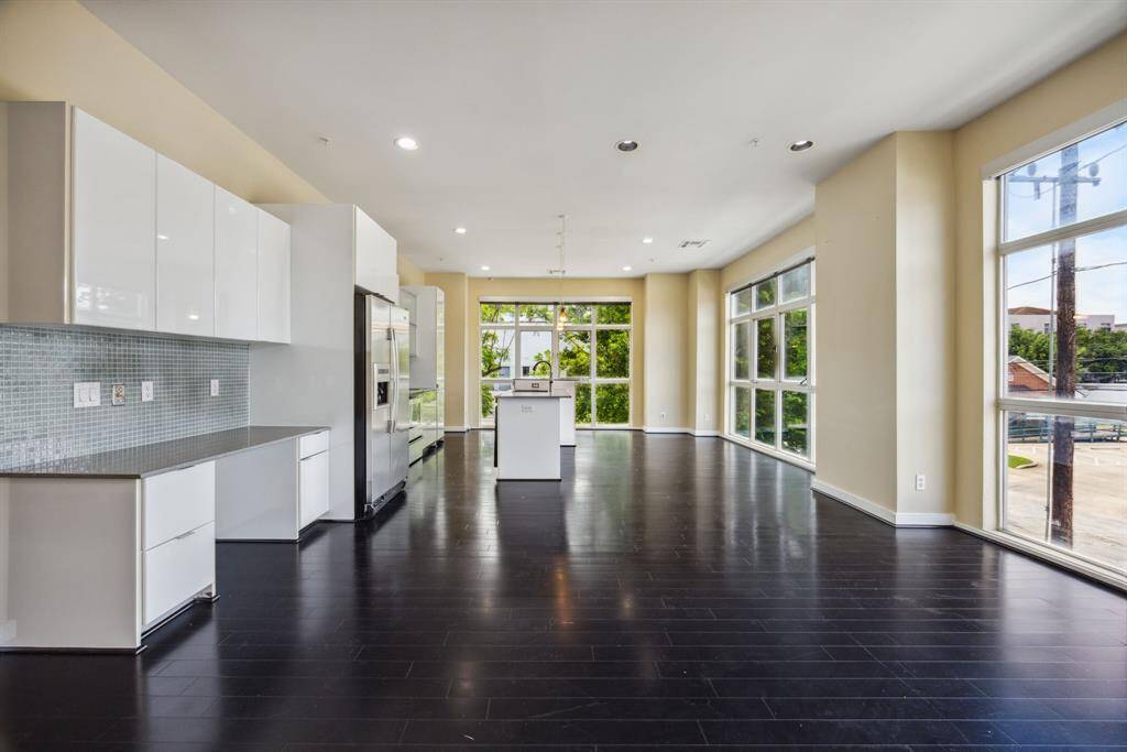 Modern kitchen with white cabinetry and sleek appliances.