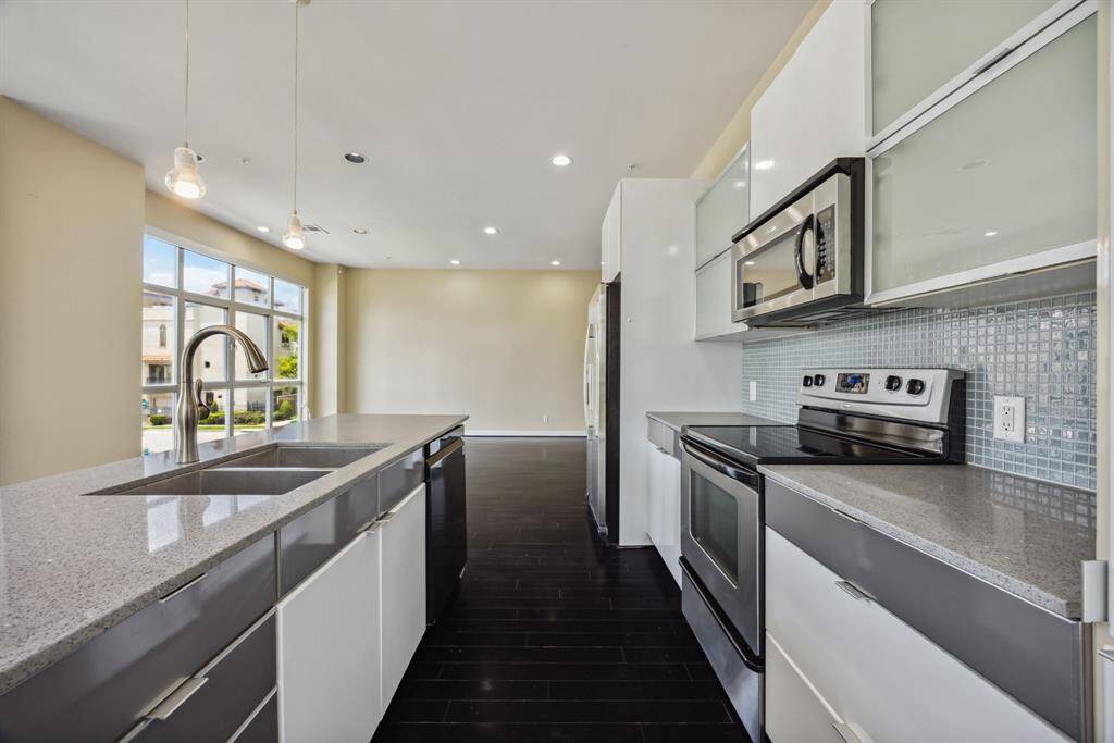 Quartz countertops throughout with stainless steel appliances.