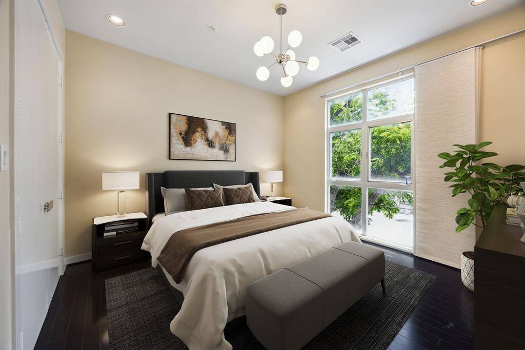 Virtually staged. This bedroom is complete with an ensuite bath, walk in closet, floor to ceiling windows, and a modern sphere light fixture.