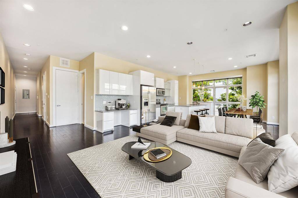 Virtually staged. Spacious living/dining/kitchen area with floor to ceiling windows.