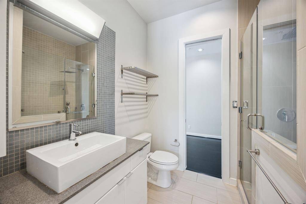 Another view of the primary bathroom with access from the hallway.
