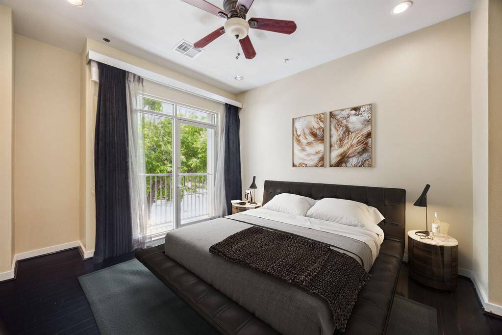 Virtually staged. This bedroom is perfect to relax with a balcony facing tree lined streets.