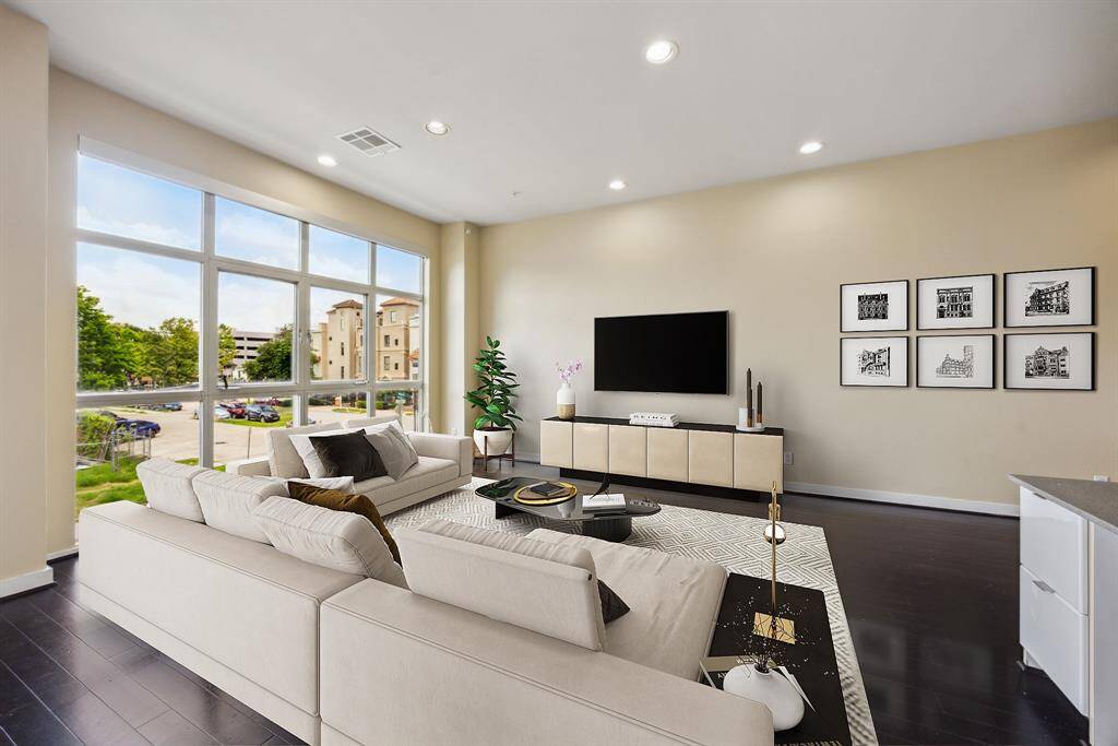 Virtually staged. The large floor to ceiling windows let in an abundance of natural light.