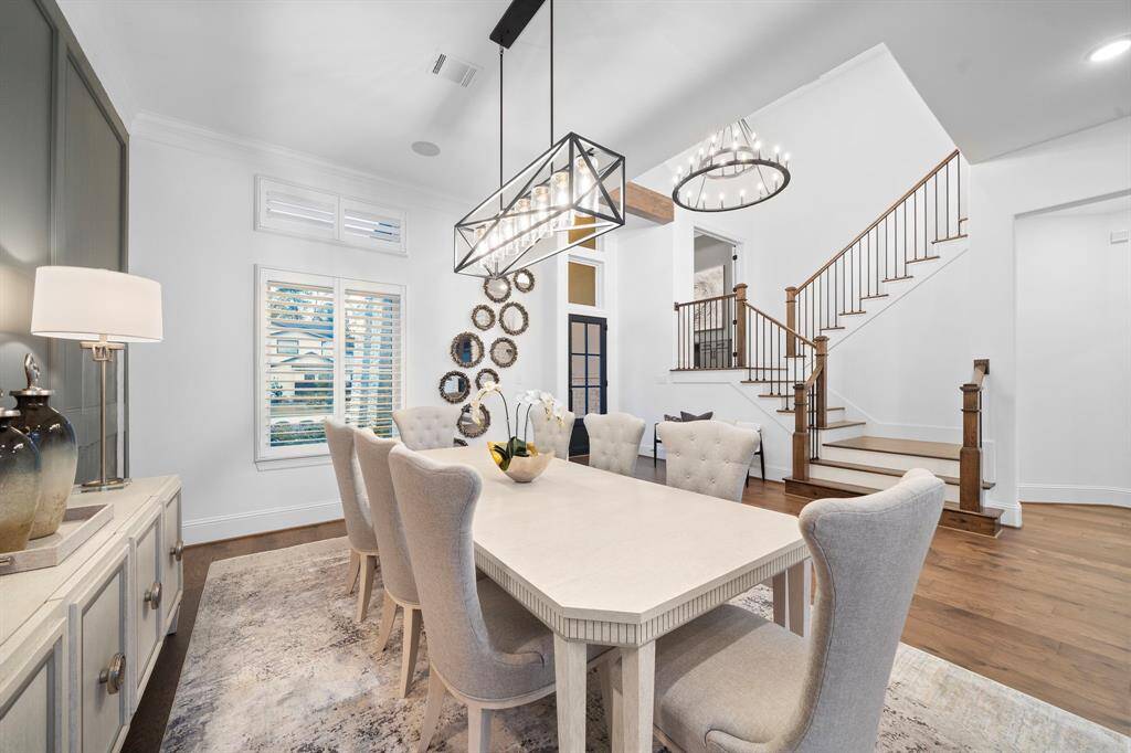 Positioned just off the foyer and kitchen, this central dining space offers seamless flow for entertaining, while designer lighting adds a sculptural finish overhead.