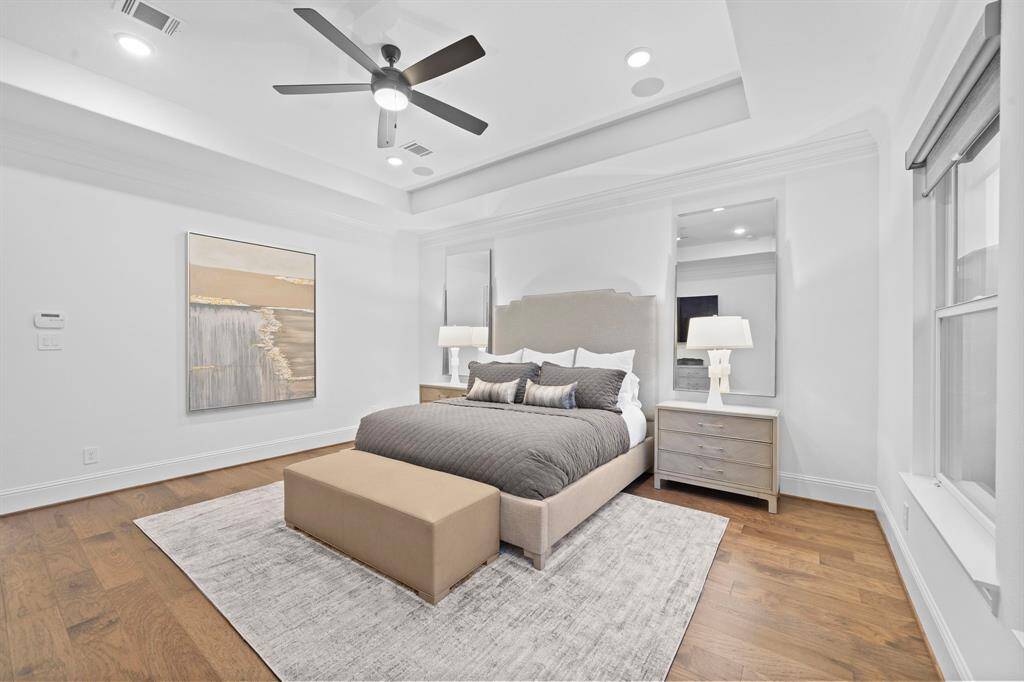 The room’s generous footprint allows for both restful function and visual balance, while the upgraded subflooring enhances the everyday experience with an added layer of acoustic comfort.