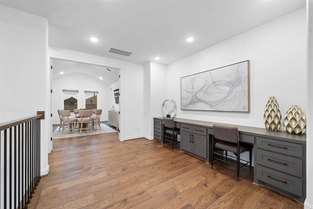 A multifunctional landing offers a built-in dual desk setup perfect for homework, remote work, or everyday organization—all set just off the upstairs bedrooms for convenient access.