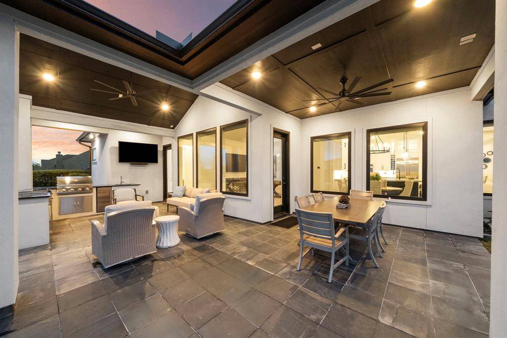 Defined by its generous layout and multiple conversation zones, this outdoor space is ideal for relaxed evenings and shared meals.