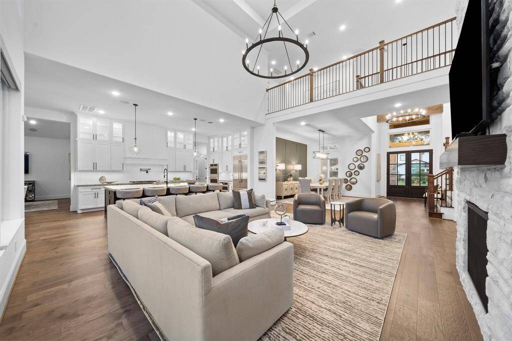 From this angle, the open two-story layout reveals the foyer and upper landing, reinforcing the home’s sense of volume and architectural continuity.
