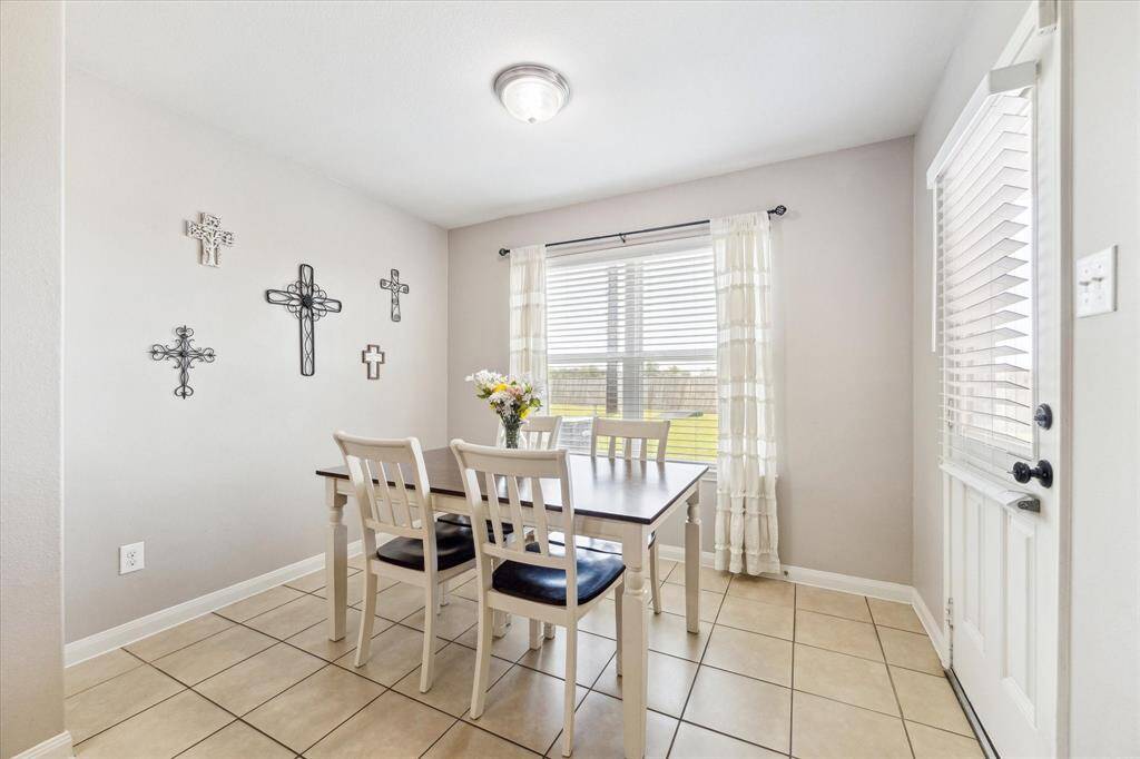 BREAKFAST AREA OVERLOOKS THE EXPANSIVE BACKYARD.