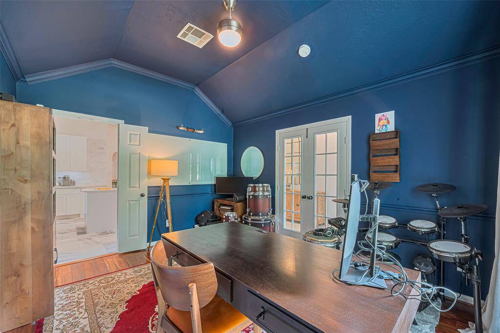 This office boasts vaulted ceilings with French doors for privacy and also provides access to kitchen as well.