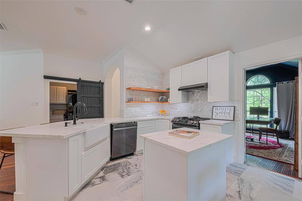 The renovated kitchen with new appliances is the heart of this home