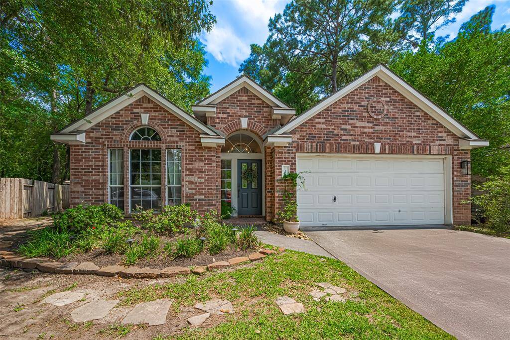 Charming, single-story brick home with an inviting front yard features large arched windows surrounded by mature trees on this quiet cul de sac street.