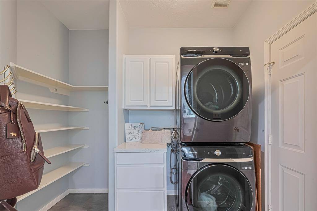 Convenient utility room with direct access to the garage.