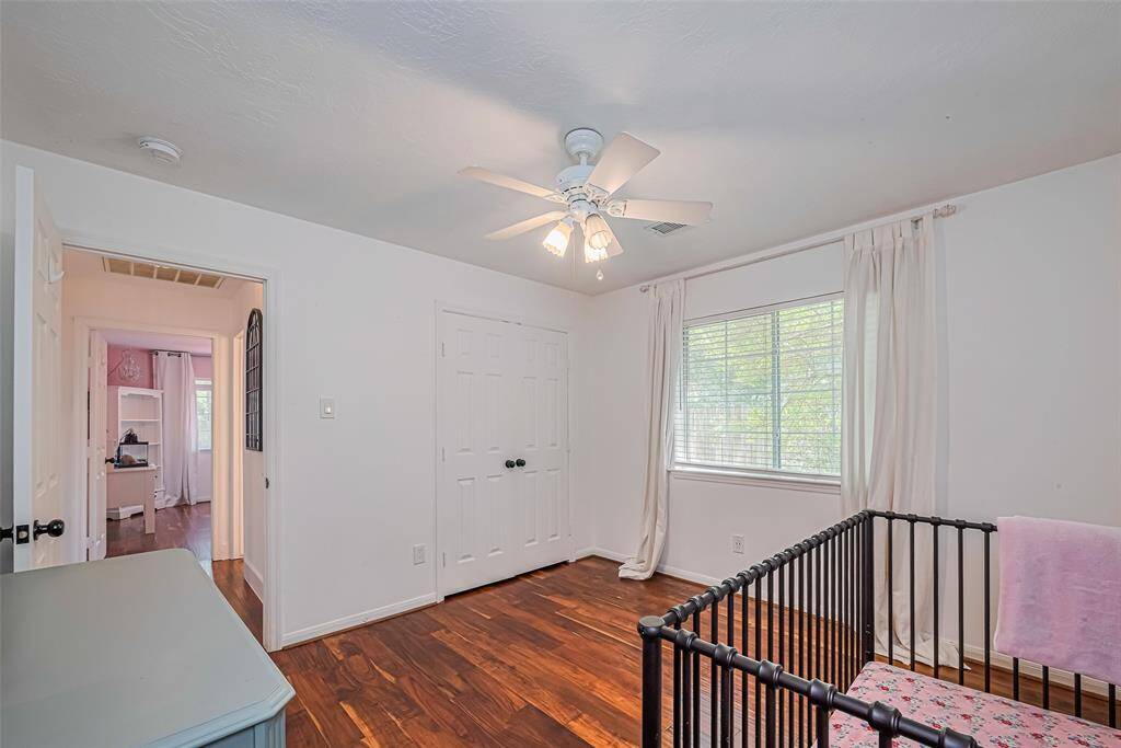 This room is a bright, cozy and no carpets in this home!   It features a closet with double doors and an adjacent hallway leading to another room and a full bathroom.