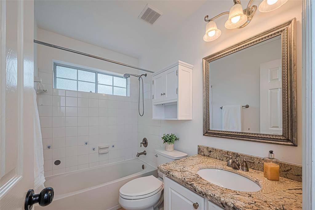 This full hall bath offers easy access for both bedrooms, perfect for family or guests.