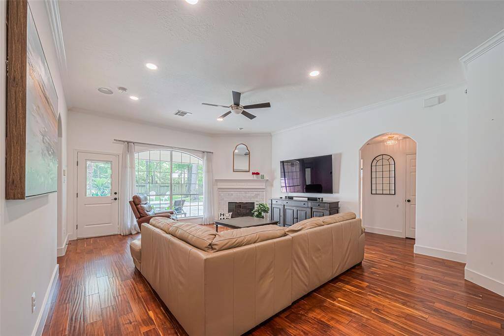 The kitchen opens up to this central living area with 2 bedrooms and a full bath to the right and the primary to the left