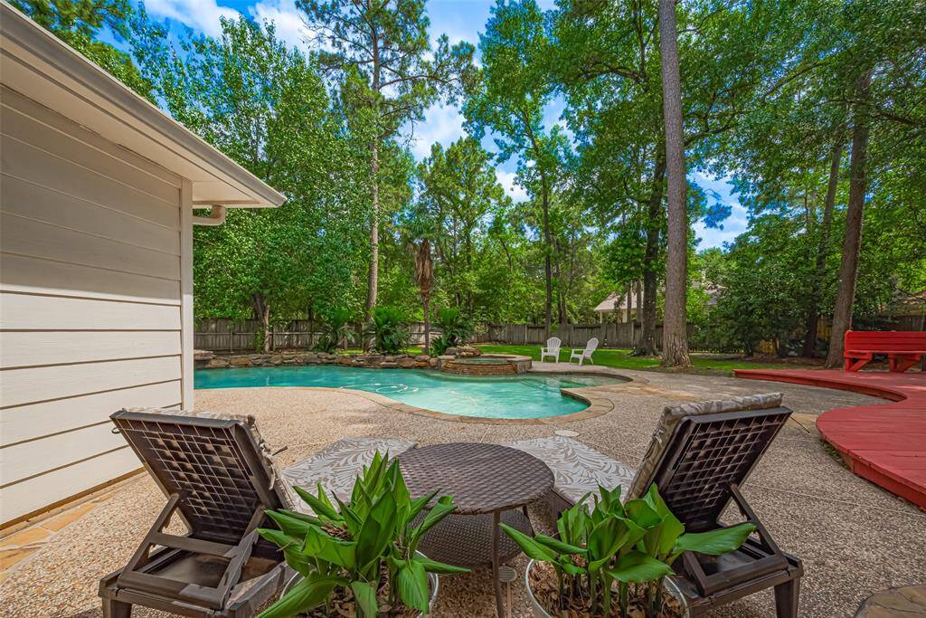 Magnificent backyard paradise, with a double lot, swimming pool, heated Hot tub, a large deck and plenty of shade trees