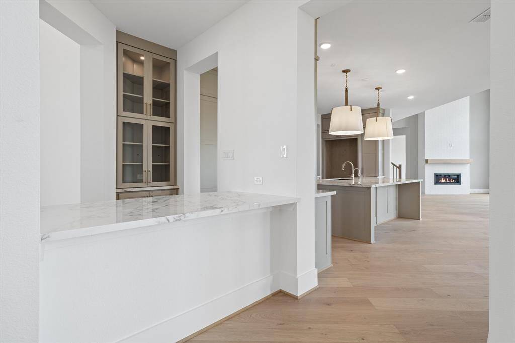 Beautifully designed butler’s pantry connects the kitchen and formal dining.