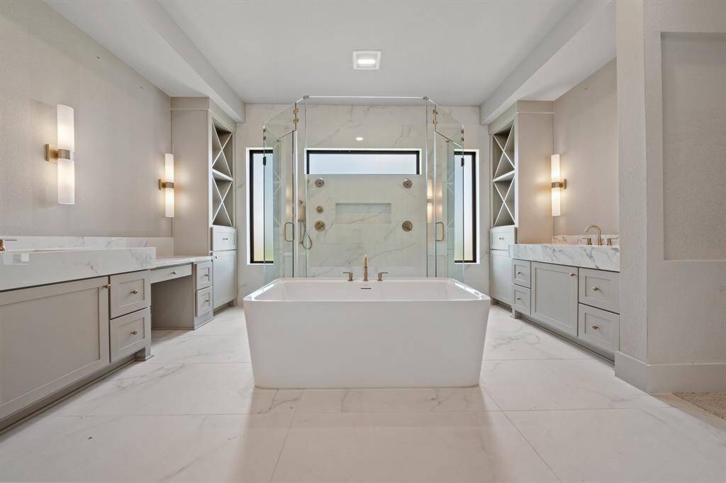 Retreat to a spa-like main bathroom with a freestanding tub and dual showerheads for the ultimate in relaxation.