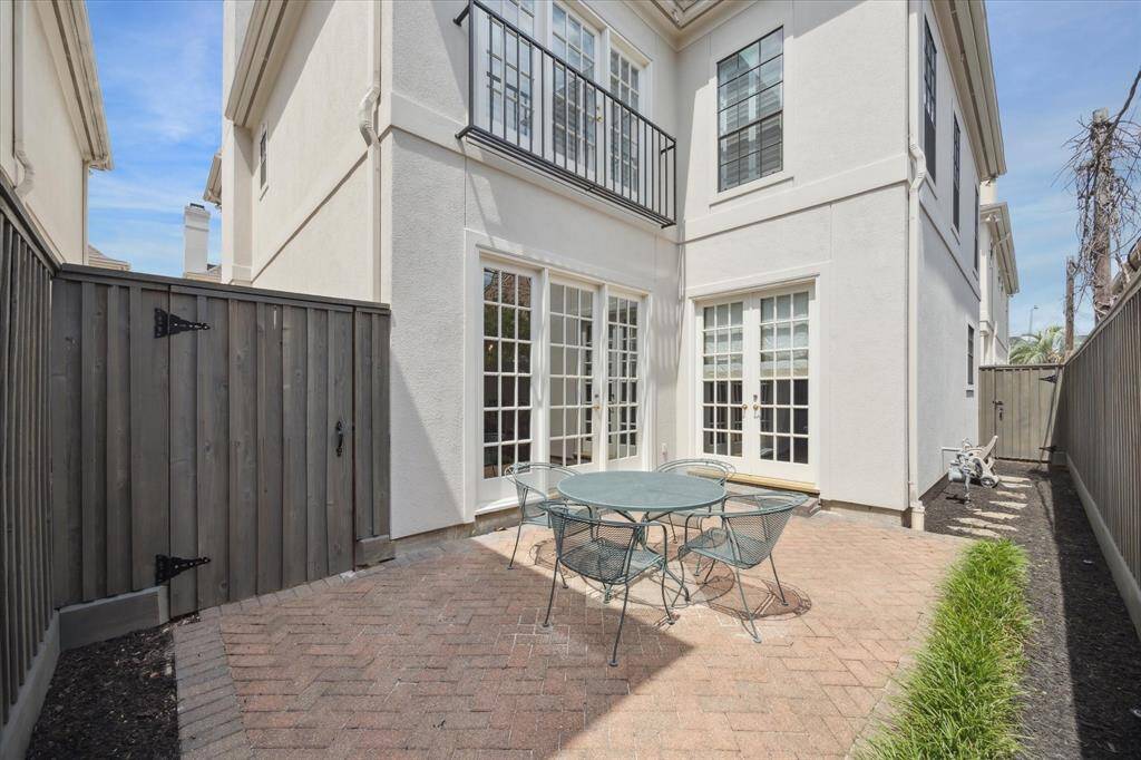 Patio - Lovely patio area with herringbone patterned brick pavers. Recently stained (2025) fence.
