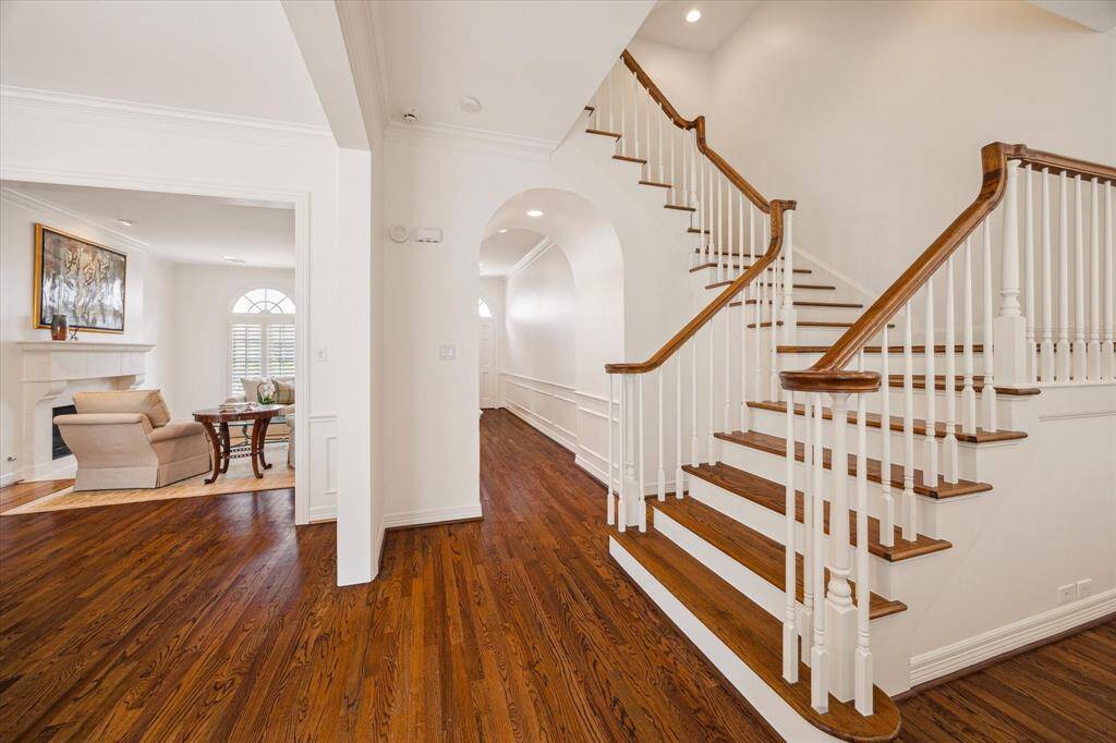Staircase - Hardwood treaded staircase lands between the dining room and den.