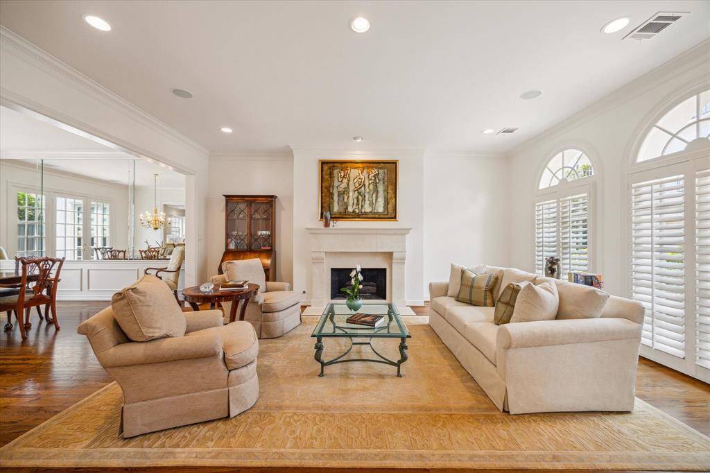 Living Room - Arched transom windows above the oversized windows allow for wonderful natural light. Note the surround sound, gas fireplace, recessed lighting and generous entry ways.